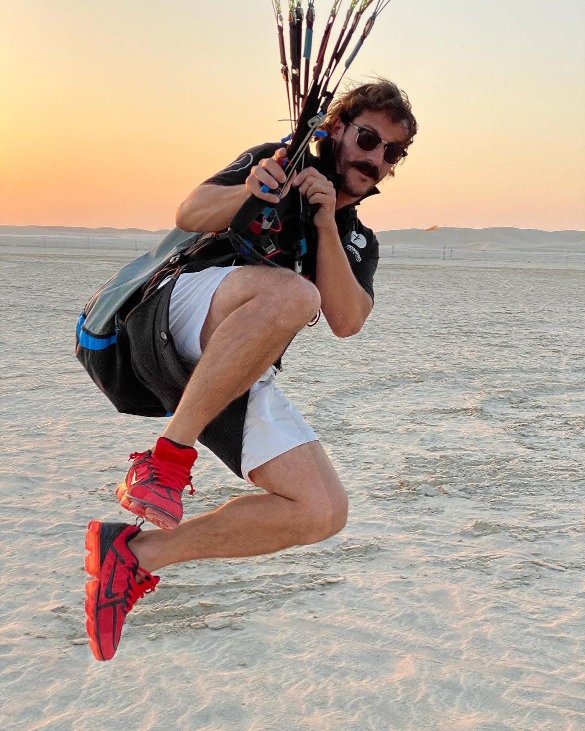 Javi tucked mid-air at sunset on the sand flats